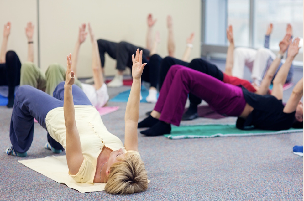 Ladies doing Pilates bridge at fitandhappy class